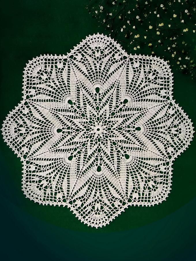 a white doily sitting on top of a green surface