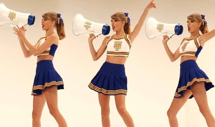 a woman in a cheerleader outfit holding a megaphone