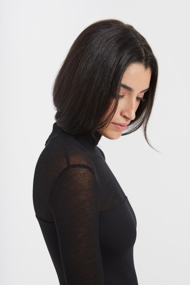 Beautiful simplicity. Our Marina is an elegant but subtly arresting midi dress with a turtleneck, European sheer jersey neckline, and extra long sleeves. She's fashioned from our softer, structured, mid-stretch European ponte for a body-hugging fit. We recommend wearing Marina with a strapless bra. [SPLIT] Sam is 5'8" (173 cm) tall, wearing size XS. Total length approximately 50" (127cm). European Ponte (also known as Punto di Roma) (60% Viscose / 30% Polyamide / 10% Lycra). Sheer European Jerse Marina Dress, Extra Long Sleeves, Strapless Bra, Simply Beautiful, High Neck Dress, Black Dress, Turtle Neck, Bra, Midi Dress