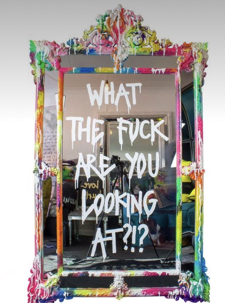 a mirror with graffiti written on it and what the f k are you looking at?