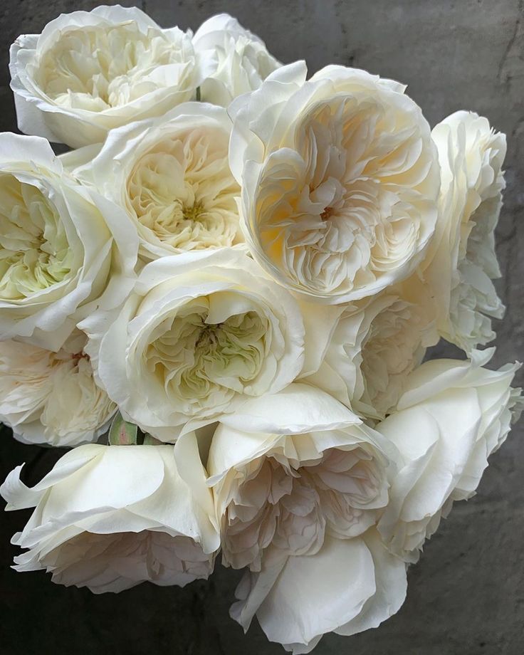 a bouquet of white flowers sitting on top of a table