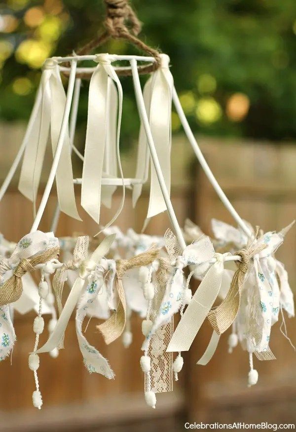 an old fashioned wind chime with ribbons hanging from it