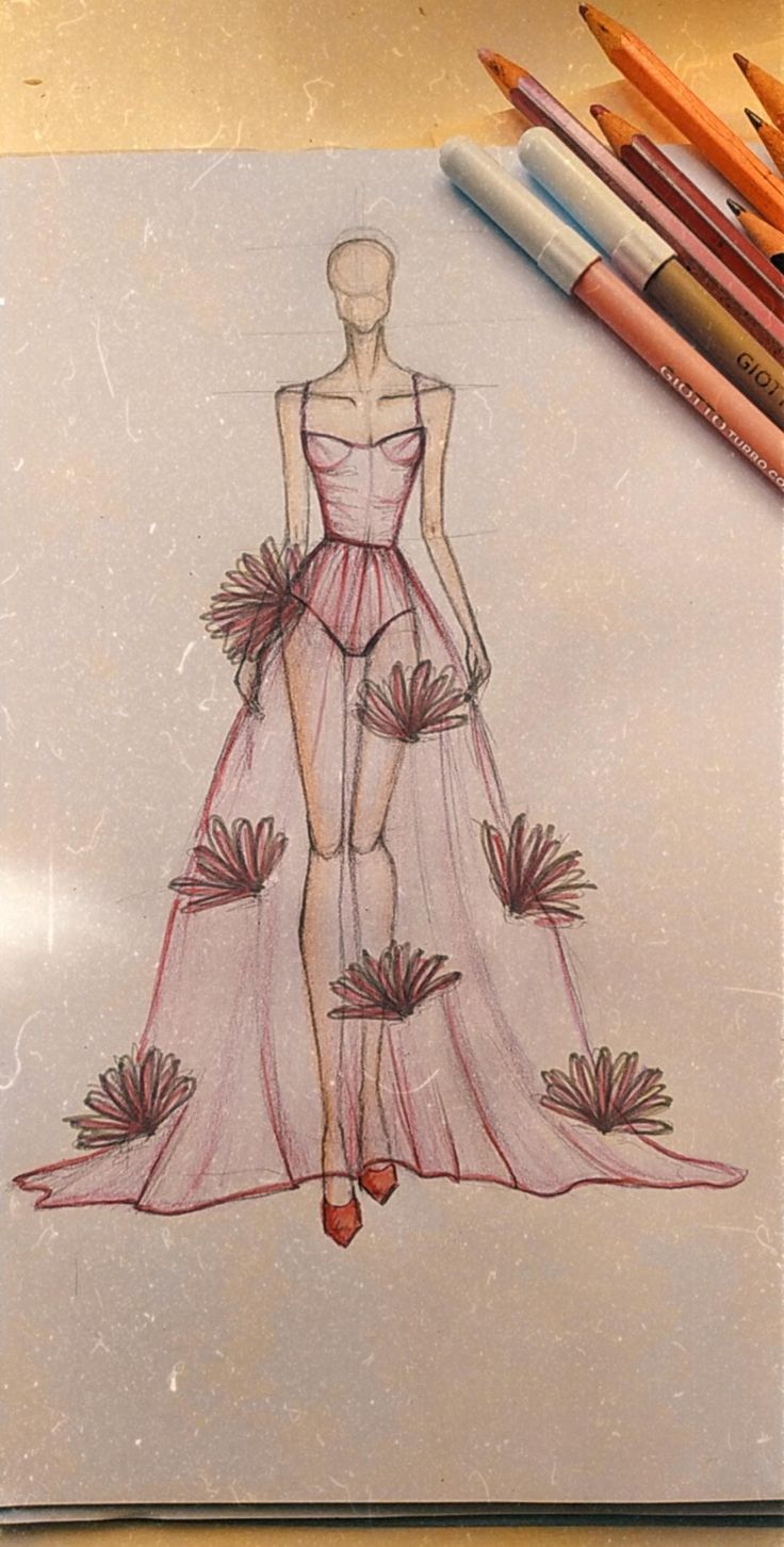 a drawing of a woman in a pink dress with flowers on the skirt, surrounded by crayons