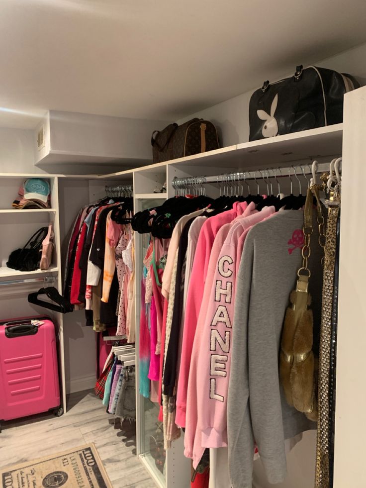 an organized closet with clothes and handbags