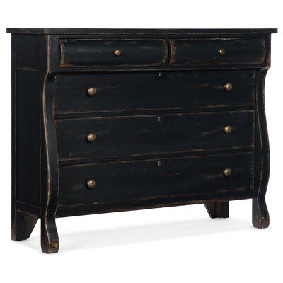 an old black dresser with brass knobs on the top and bottom drawers, against a white background