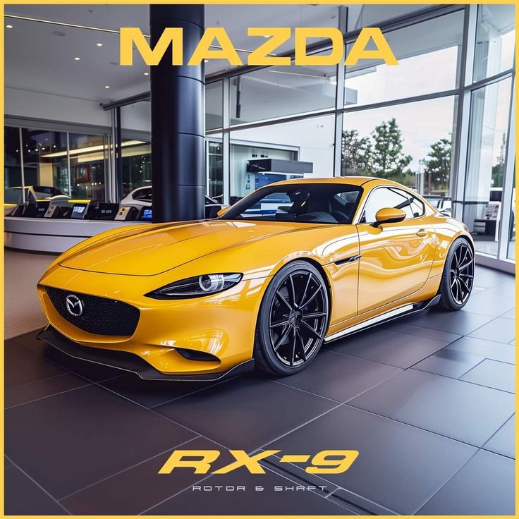 a yellow mazda sports car parked in front of a building with the words mazda next to it