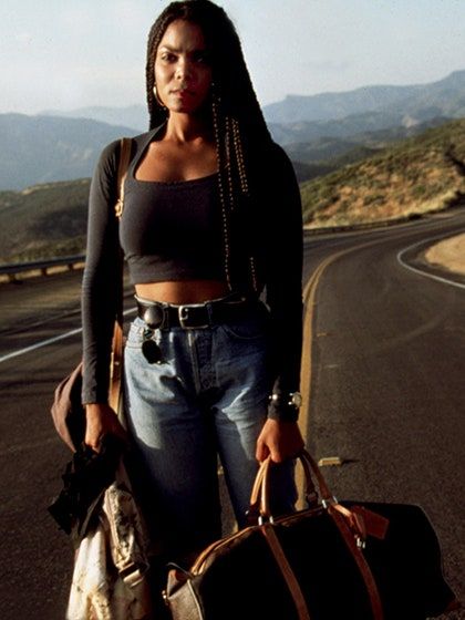 a woman holding two bags on the road