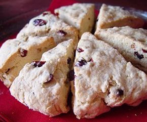 a red plate topped with scones covered in blueberries