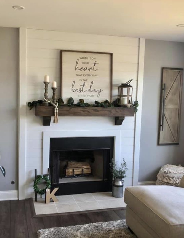 a living room filled with furniture and a fire place in front of a white fireplace