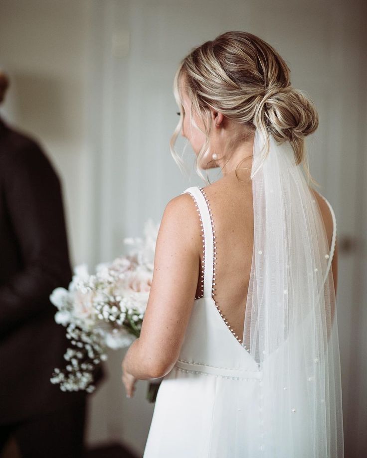 a woman in a wedding dress standing next to a man