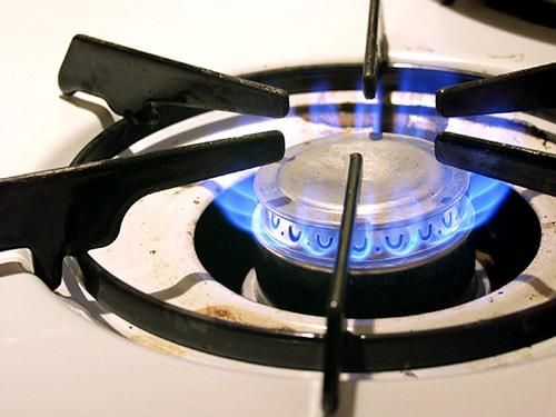 a gas burner with blue flames on the top is seen in this image taken from above