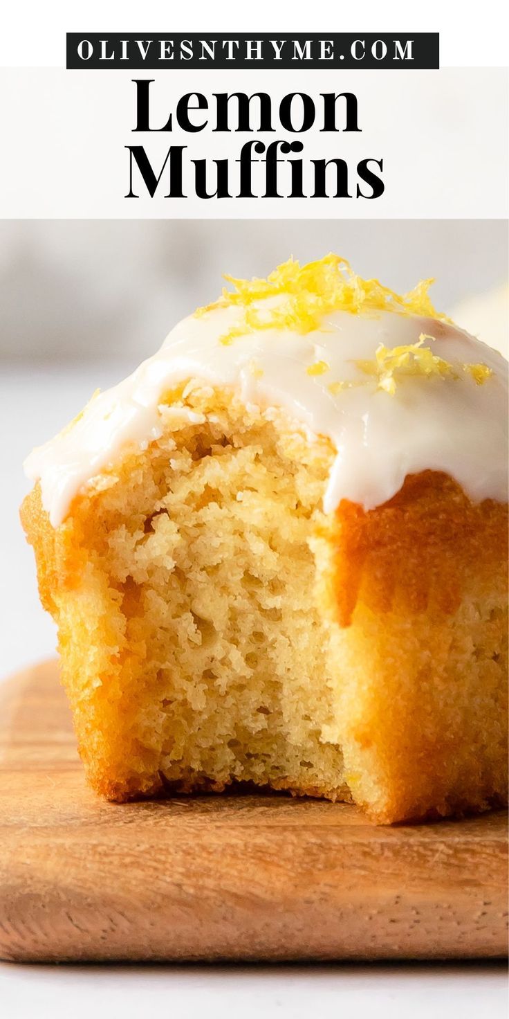 a close up of a muffin on a cutting board with frosting and lemons