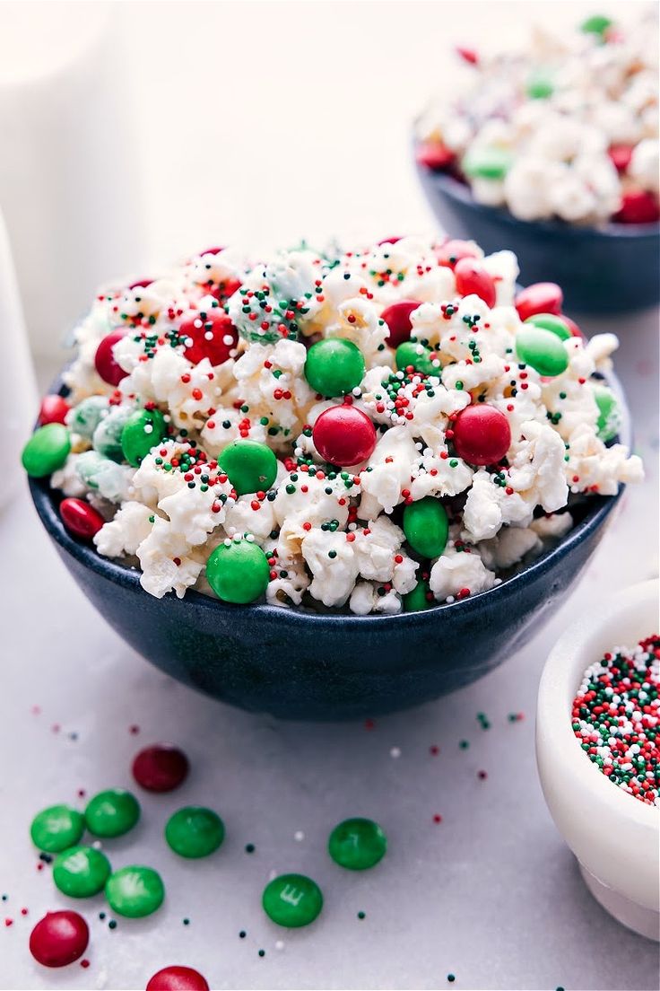 two bowls filled with christmas popcorn and sprinkles