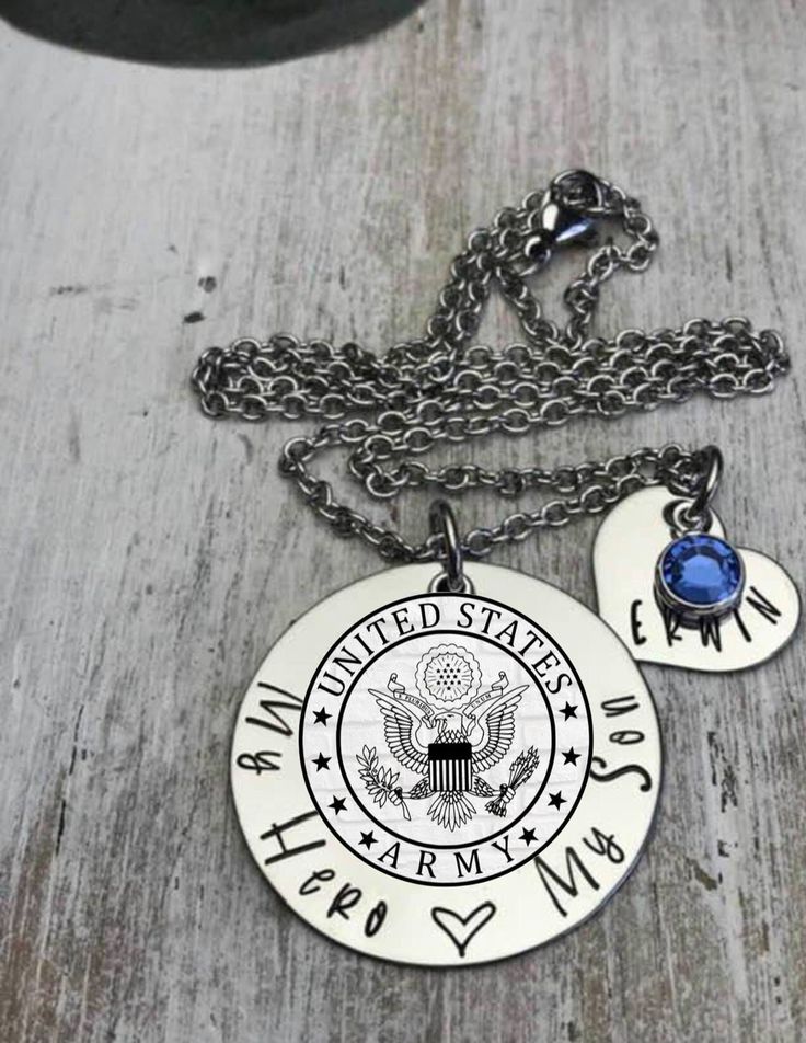 "OFFICIAL LICENSEE OF THE DEPARTMENT OF THE ARMY This listing includes a 1 1/4\" stainless steel washer hand stamped with My hero, My Love My Life, a sublimated U.S. Army charm (please note that photo is a mock up, your charm will be silver) on your choice of stainless steel chain or key chain. Optional purchase of a 5/8\" stainless steel heart stamped with name and birthstone. Birthstone is only included with the purchase of the heart. Birthstone will not be included if heart is not purchased. My Love My Life, Proud Army Mom, Military Jewelry, Mom Gift Basket, Love My Life, Army Mom, Heart Stamp, Military Family, Mom Necklace