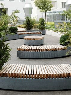 an outdoor seating area with benches and trees