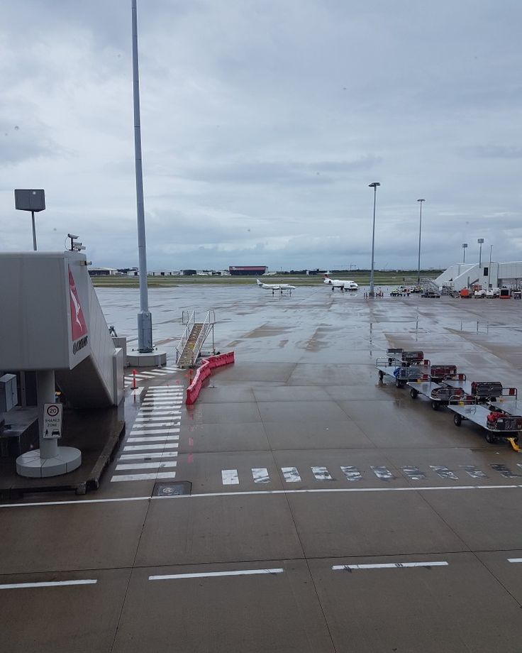 an airport tarmac with several planes parked on it