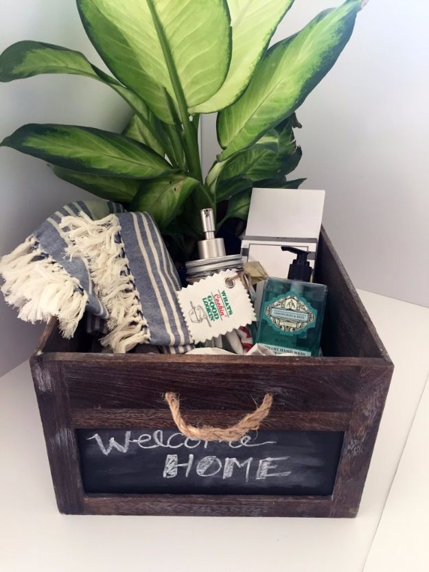 a welcome home sign in a wooden box filled with personal care items and a potted plant