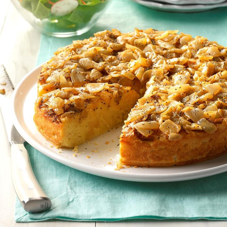 a white plate topped with a cake covered in nuts