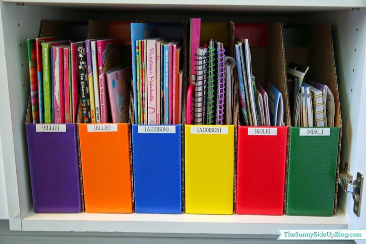 a book shelf filled with lots of books and binders on top of each other