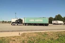 two semi trucks are parked in a parking lot