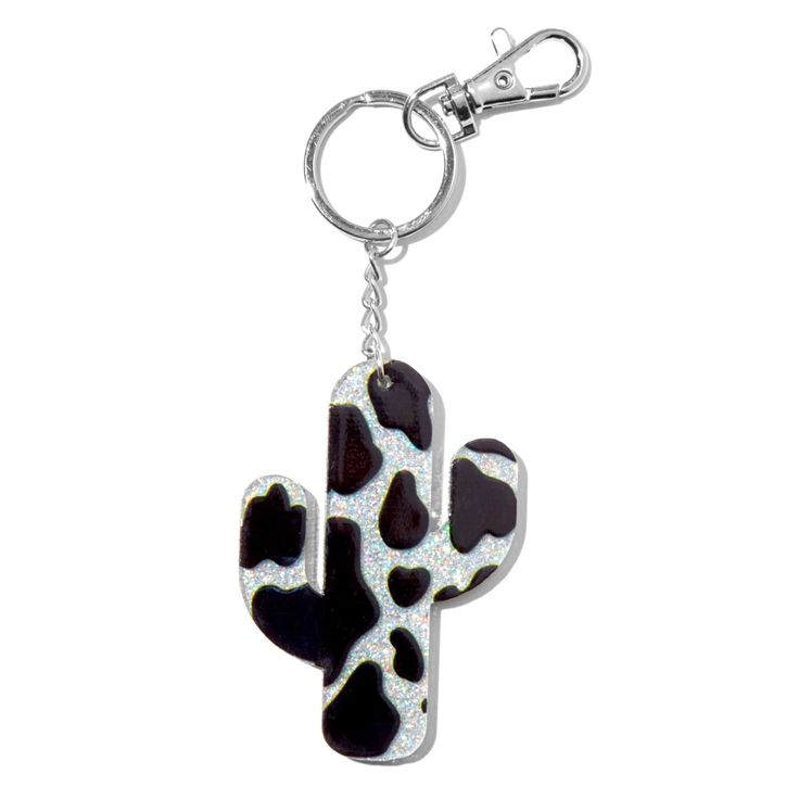 a key chain with a black and white cactus design on the front, hanging from a metal hook