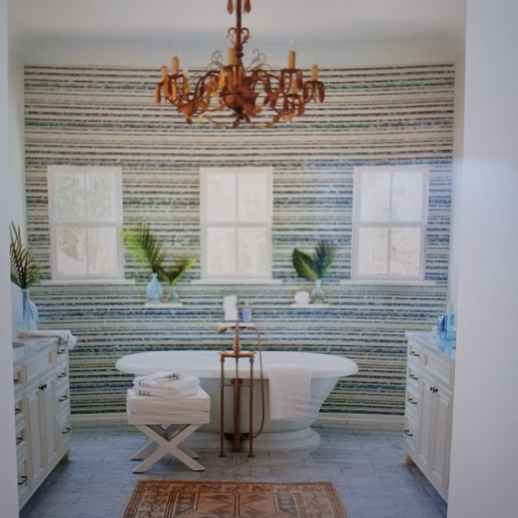 a bathroom with a chandelier and tub in it