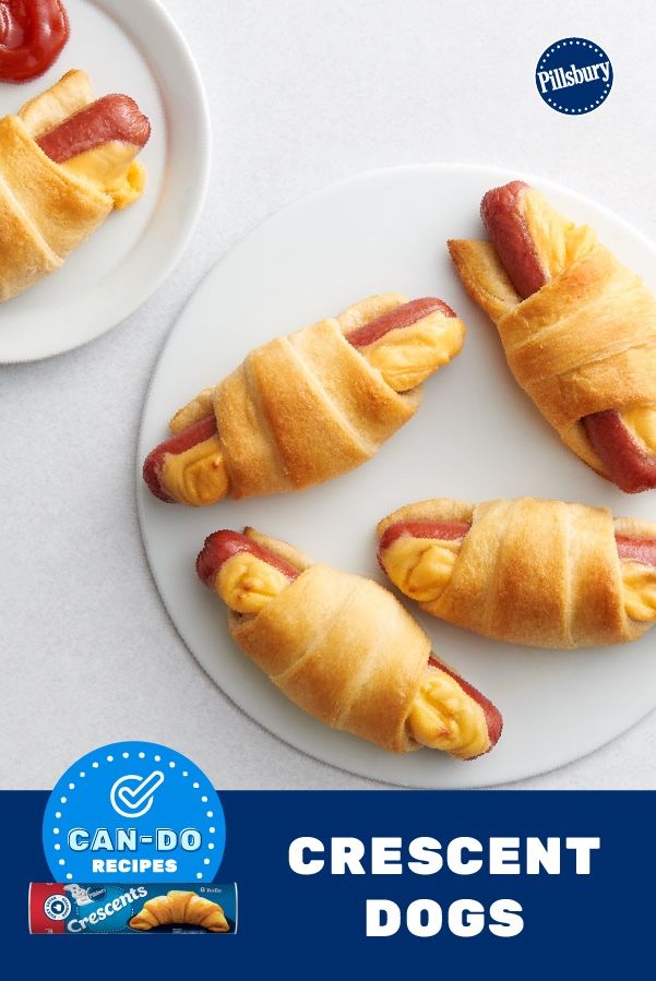 two white plates with hot dogs wrapped in crescent rolls