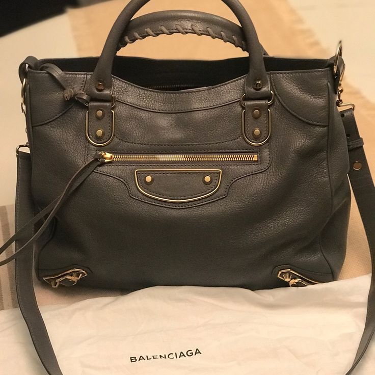 Balenciaga Hand Bag. Brand New With Tags Never Used Luxury Gray Satchel Bag, Luxury Gray Shoulder Bag With Dust Bag, Designer Gray Satchel Bag, Designer Gray Tote Bag, Classic Gray Bags With Gold-tone Hardware, Luxury Gray Shoulder Bag With Double Handle, Designer Gray Shoulder Bag, Designer Gray Bags For Daily Use, Designer Gray Top Handle Shoulder Bag