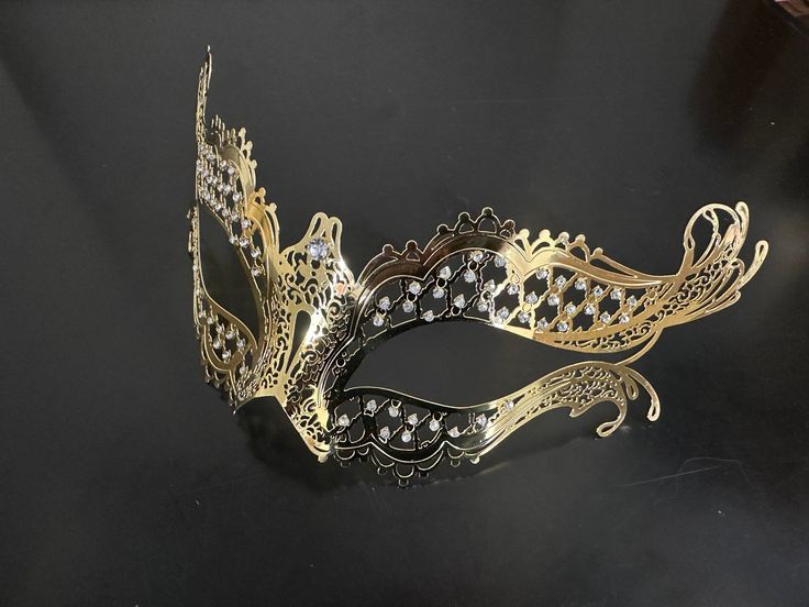 Enchant with our gold couples masquerade masks. The men's mask boasts a Venetian-style charm, while the women's mask is a vision of elegance with rhinestones. Together, you'll create an unforgettable duo that exudes sophistication and allure at any masquerade party or ball!


Age Group/Gender - Adult/Unisex

Size/Type - One size fits all adults

Mask Color - Gold

Mask Material - Men's: Polyresin, Women's: Laser Cut Metal

Accent Material - Paint

Special Features - Rhinestones Elegant Masquerade Mask For Mardi Gras, Elegant Gold Mask For Masquerade, Elegant Mardi Gras Masquerade Eye Mask, Elegant Mardi Gras Masquerade Mask, Elegant Mardi Gras Eye Mask, Elegant Masquerade Mask For Festivals, Gold Adjustable Masquerade Mask, Elegant Masquerade Eye Mask, Gold Eye Masquerade Mask