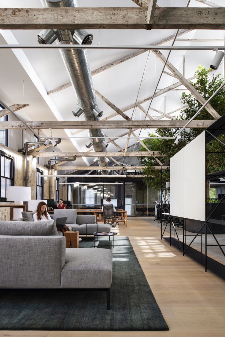 an office with couches and tables in the middle