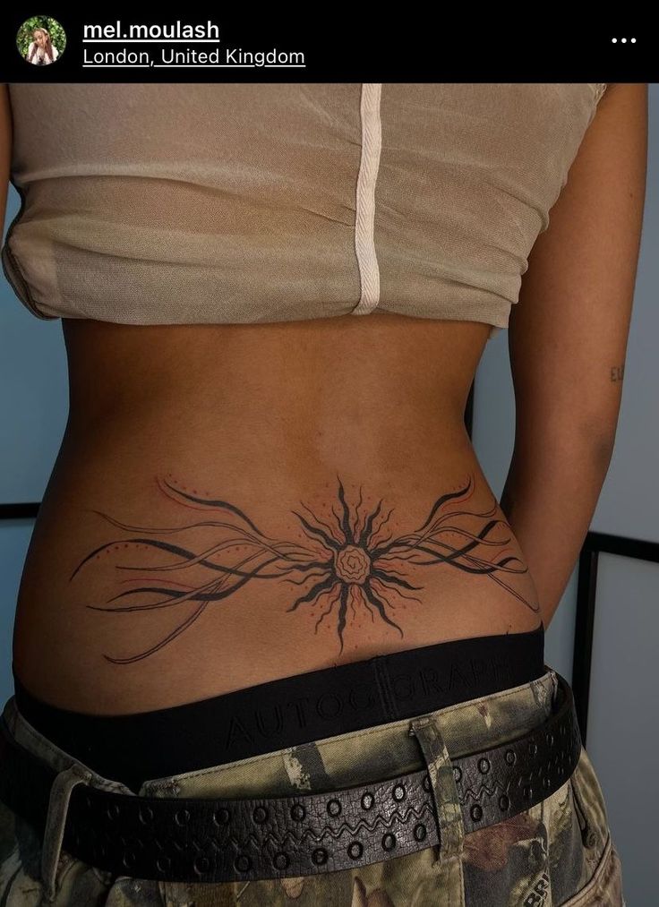 a woman with a tattoo on her stomach