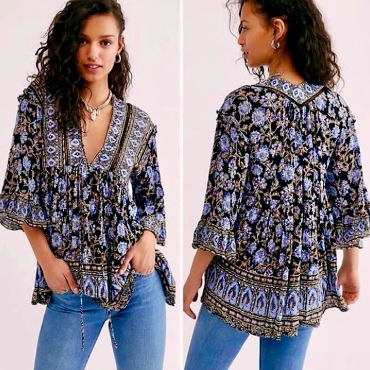 Embrace Your Inner Goddess In This Strikingly Beautiful Tunic From Free People, In An Exquisite Batik Floral Print Full Of Rich Blues, Camel Brown, Ivory & Black. Gorgeous As A Sexy Mini Dress Or Tunic Top Worn With Jeans. Full Of Intricate Details, It Features A Loose Flowy Silhouette, Deep V-Neckline With Self-Tie Closure, Crochet Inset, Drop Shoulders With Ruffle Details, Flared Sleeves With Wide Ruffles, Side Pockets & High-Low Hemline. 100% Viscose. Generously Sized. Approx. Bust 21, Length Black Bohemian Tops With Boho Print, Black Boho Print Tops For Spring, Spring Black Boho Print Tops, Black Bohemian Top With Boho Print, Black Floral Print Blouse For Festival, Black Bohemian Blouse With Floral Print, Black Bohemian Printed Blouse, Black Floral Print Festival Blouse, Bohemian Patterned V-neck Peasant Top