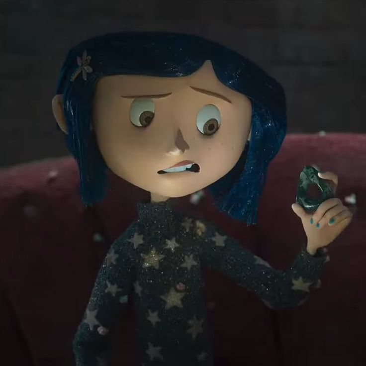 a cartoon character holding something in her hand and looking at the camera with an evil look on his face