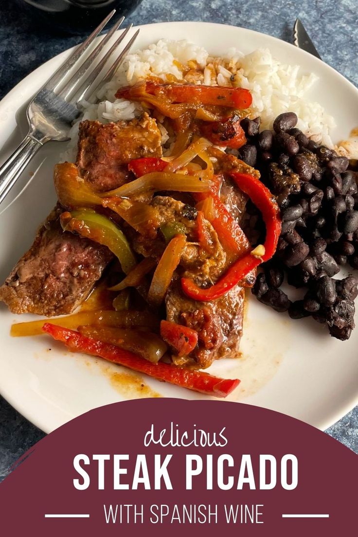 a white plate topped with meat and vegetables next to rice, beans and black beans