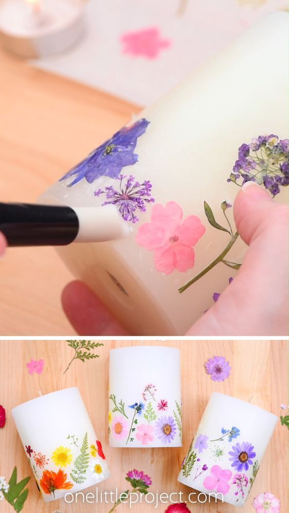 someone is painting flowers on the side of a cup and then using a brush to decorate it