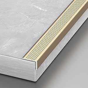 a white and gold book sitting on top of a gray table next to a wall