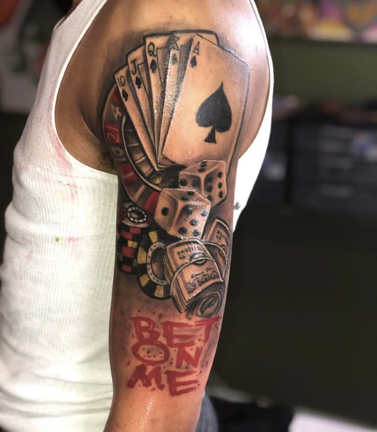 a man's arm with playing cards and dice on it