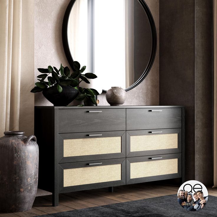 a black and white dresser sitting in front of a mirror