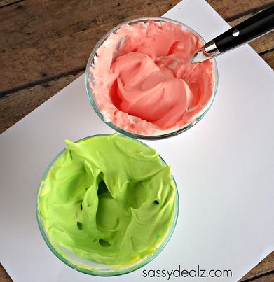 two bowls filled with food sitting on top of a white paper next to each other