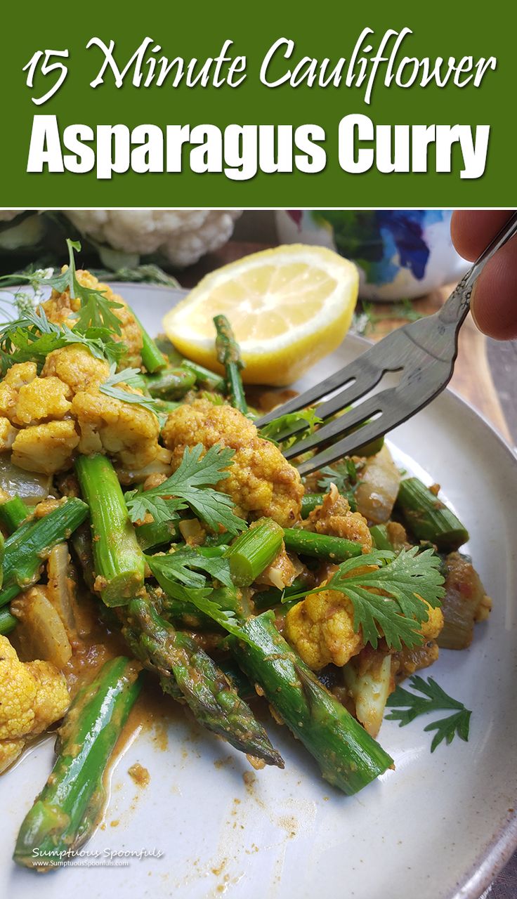 asparagus and cauliflower on a plate with lemon wedges