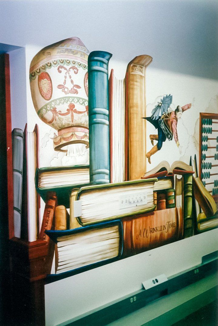 there are many books on the shelf in front of this wall mural that is painted