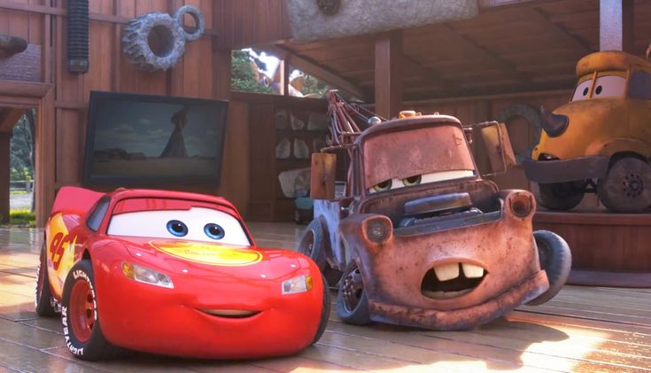 two cars are shown in front of each other on a wooden floor, one is red and the other is blue