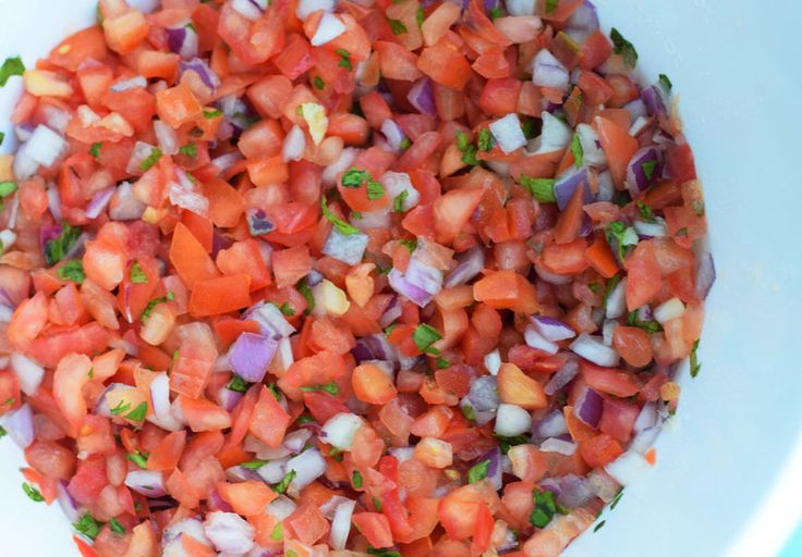 chopped vegetables are in a bowl on the table