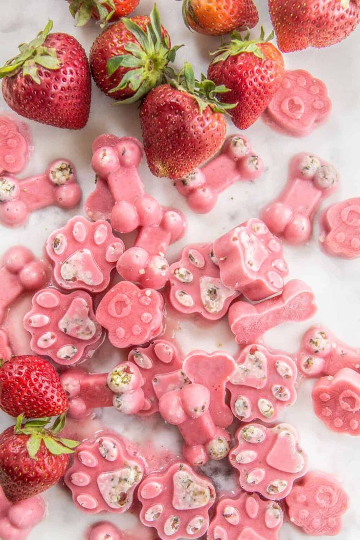 pink candy bears and strawberries on a marble surface