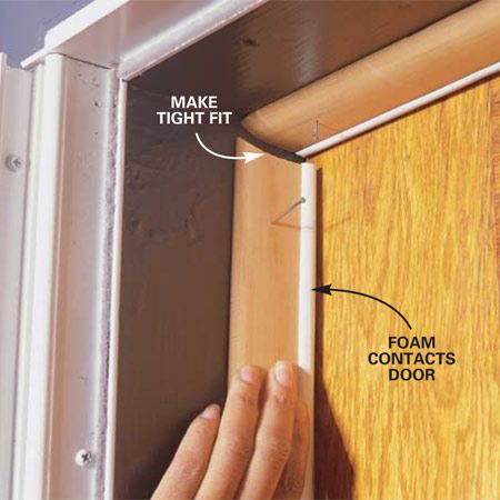 a person is opening the door with their hand and pointing at the wood paneling