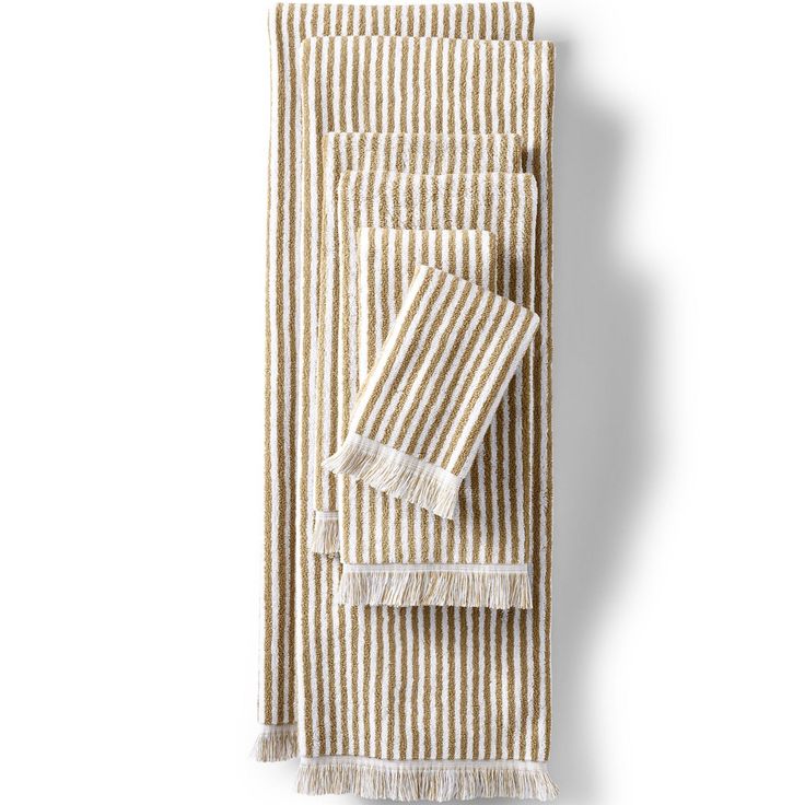 three striped towels with fringes on them