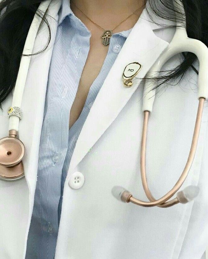 a close up of a person wearing a white coat and holding a stethoscope