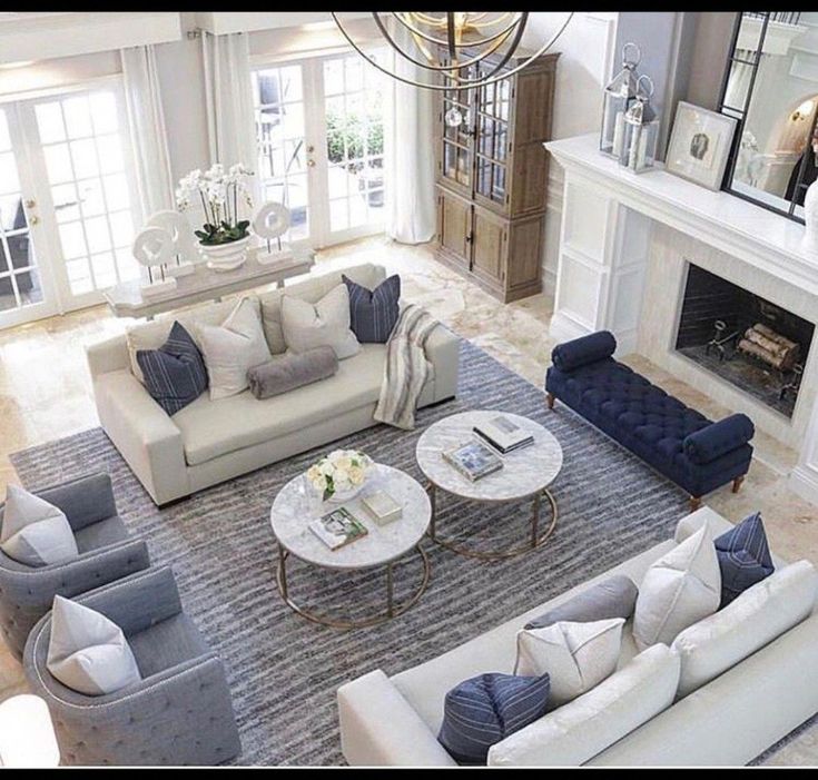 a living room filled with furniture and a fire place in the middle of a room