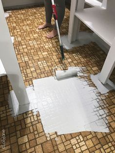 a person with a mop on the floor