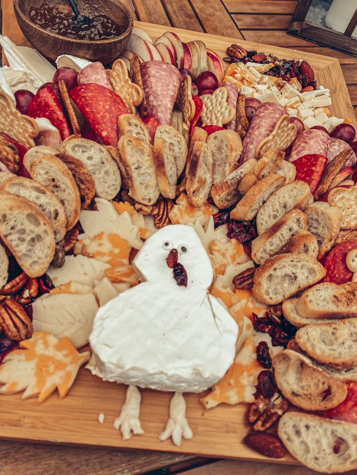 a platter filled with bread, cheese and meats